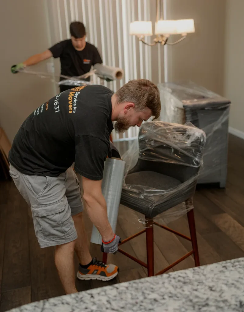 Movers setting up bedroom furniture as part of first apartment essentials checklist